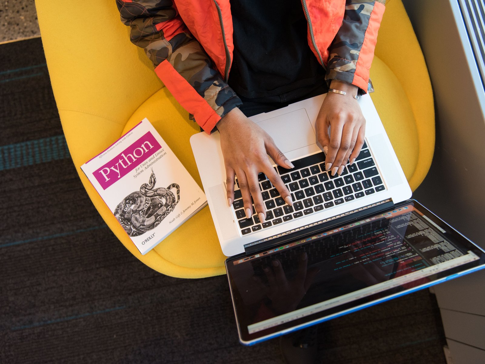 Hands typing code on a laptop for custom web development services